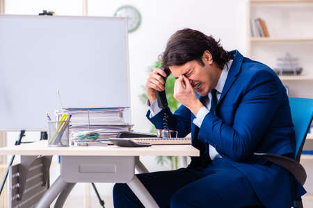Young businessman sitting and working in the officeの写真素材