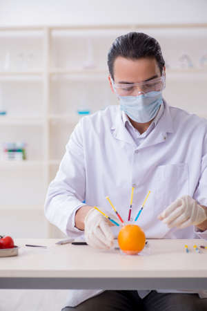 Male nutrition expert testing food products in labの写真素材