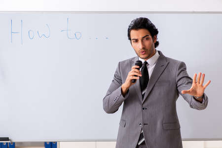 Young handsome businessman in front of whiteboardの写真素材