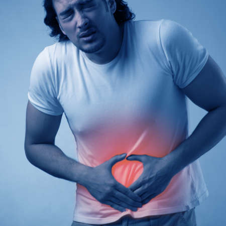 Man suffering from acute pain on abdomenの写真素材