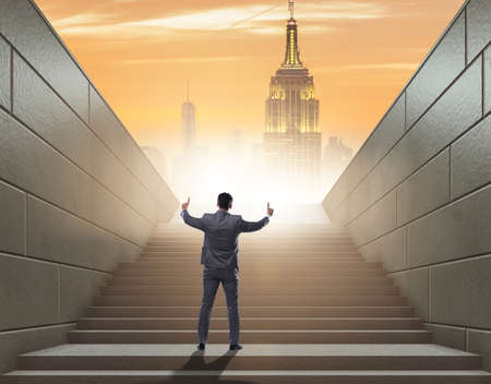 Businessman climbing up challenging career ladder in business co