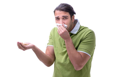 Young man suffering from allergy isolated on whiteの写真素材