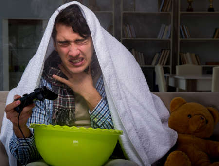 Sick man doing inhalation at night in homeの写真素材