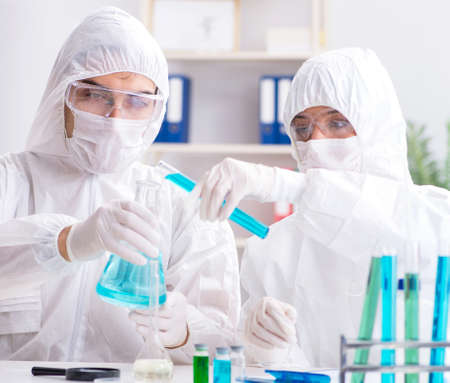 Two chemists working in the lab