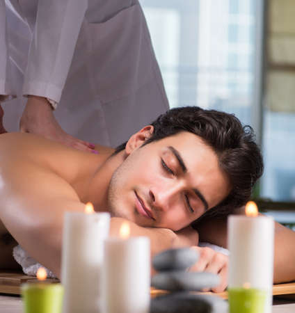 Young handsome man during spa procedureの写真素材
