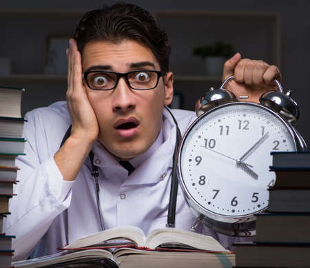 Medical student preparing for university exams at nightの写真素材