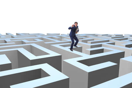 Businessman trying to escape from mazeの写真素材