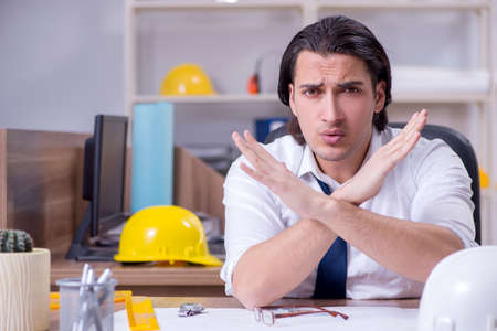 Young male architect working in the office
