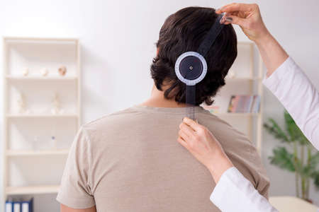 Female doctor checking patient's joint flexibility with goniometerの写真素材