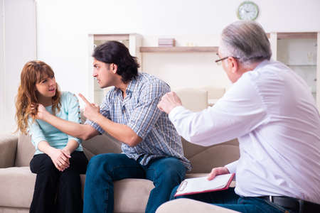 Young pair visiting experienced doctor psychologistの写真素材