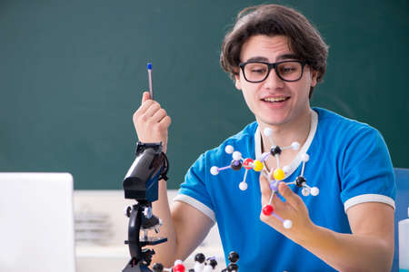 Young male student in the classroom