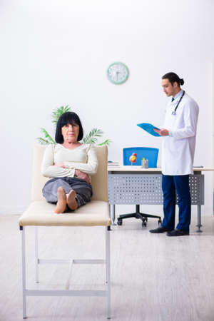 Young doctor examining senior old womanの写真素材