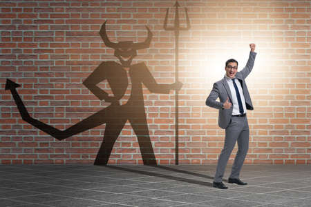 Devil hiding in the businessman - alter ego conceptの写真素材