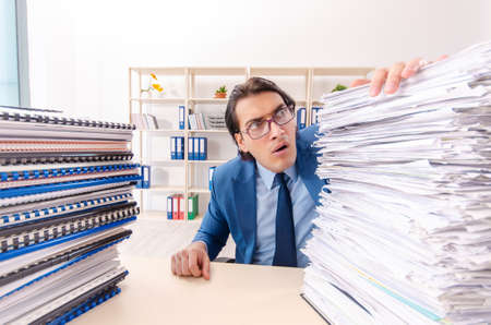 Young handsome businessman unhappy with excessive work