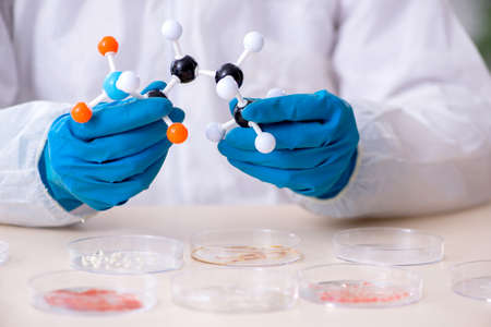 The young male chemist working in the lab