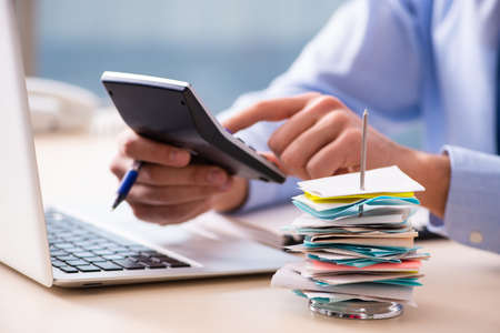 The young male employee in budget planning concept
