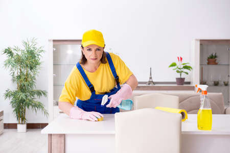 Old female contractor doing houseworkの写真素材