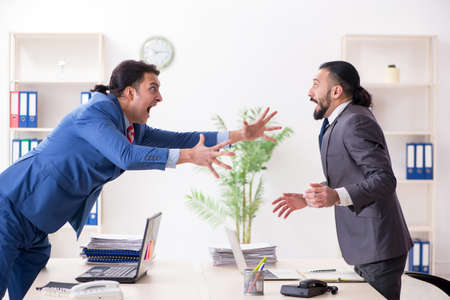 Two male colleagues in the officeの写真素材