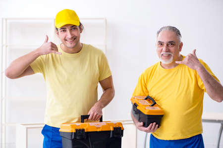 Two contractors carpenters working indoorsの写真素材