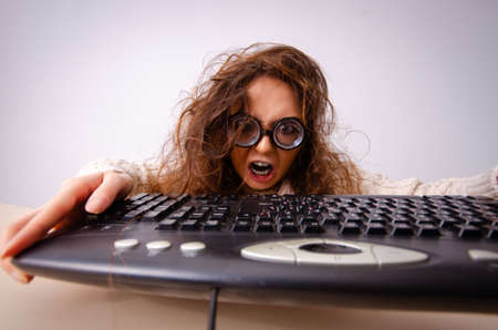 Funny nerd girl working on computerの写真素材