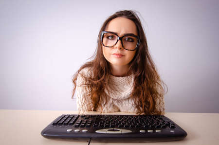 Funny nerd girl working on computer