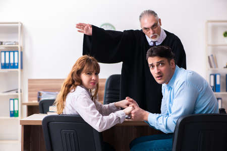 Young couple in the courthouse in divorce conceptの写真素材