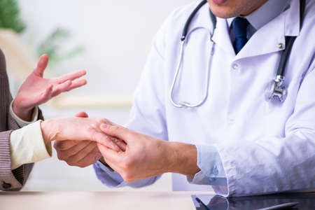 Young doctor examining senior old womanの写真素材