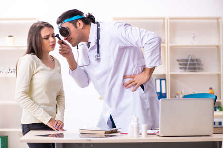 Young male doctor and female beautiful patientの写真素材