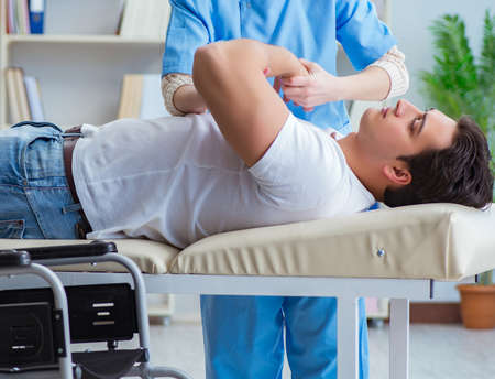 Patient undergoing rehabilitation recovery programme with doctorの写真素材
