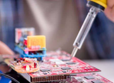 Professional repairman repairing computer in workshop