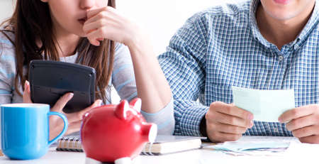 Young couple looking at family finance papers