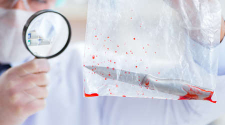 Forensics investigator working in lab on crime evidence