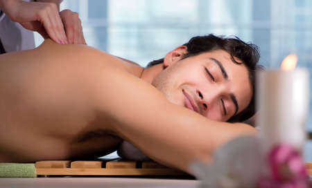 Young handsome man during spa procedureの写真素材