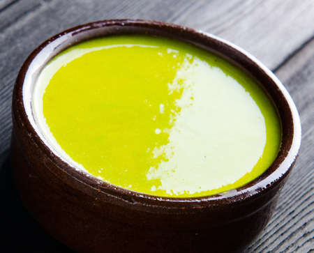 Spinach soup served on wooden boardの写真素材