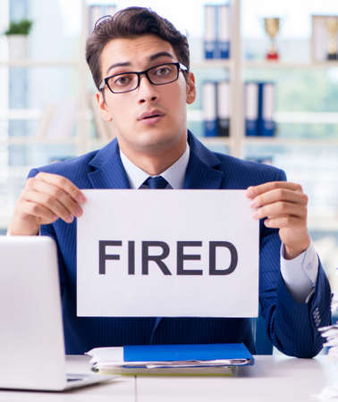 Businessman with message in the office at deskの写真素材