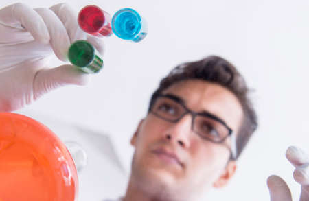 Chemist working in the laboratory with hazardous chemicalsの写真素材