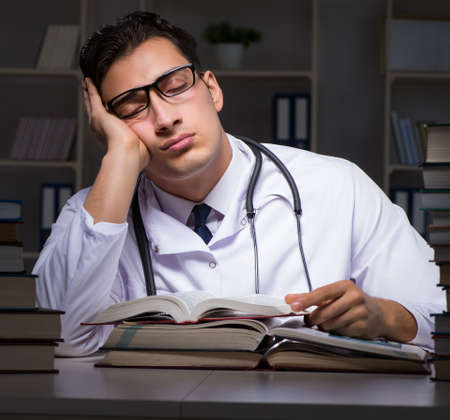 Medical student preparing for university exams at nightの写真素材