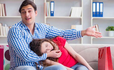 Young pair after shopping with many bagsの写真素材