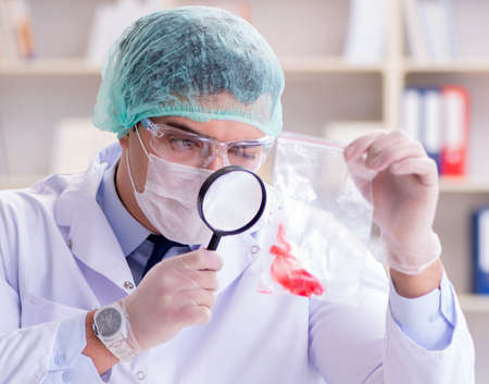 Forensics investigator working in lab on crime evidenceの写真素材