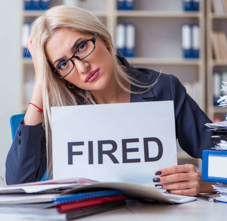 Businesswoman with message in office at deskの写真素材