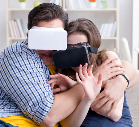 Young family playing games with virtual reality glasses
