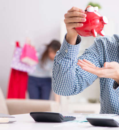 Young couple looking at family finance papersの写真素材