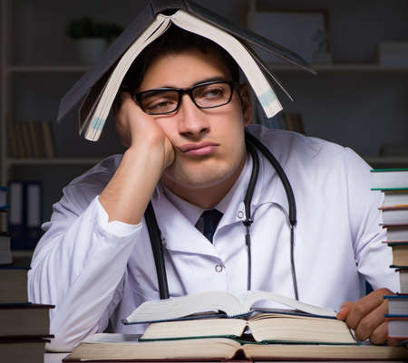 Medical student preparing for university exams at nightの写真素材