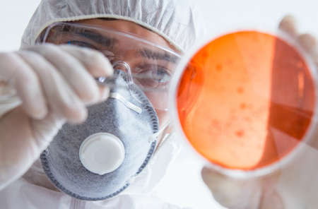 Chemist working in the laboratory with hazardous chemicals