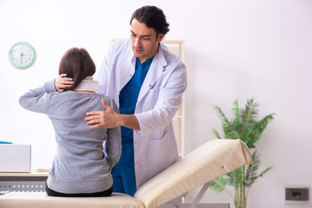 Young male doctor and female beautiful patientの写真素材