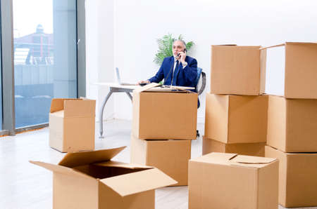 Aged businessman moving to new workplace
