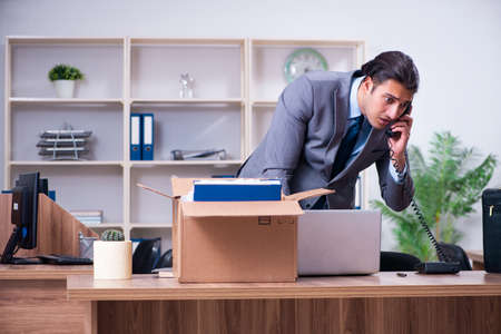 Young male employee being fired from his workの写真素材