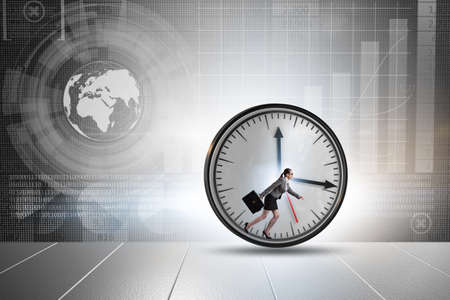 Businesswoman employee in time management conceptの写真素材