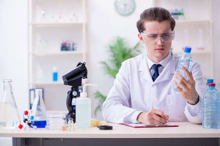 Young male chemist experimenting in lab