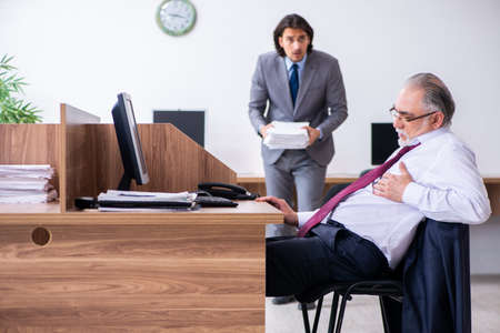 Male employee suffering from heart attack in the officeの写真素材